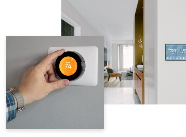 A hand adjusting a thermostat to conserve energy.